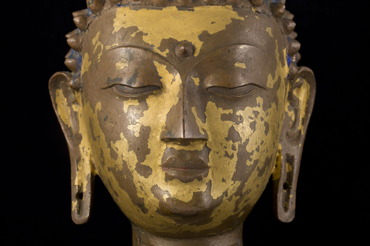 A rare Thai gilt bronze Buddha head, some blue pigment remains 16th/17th century